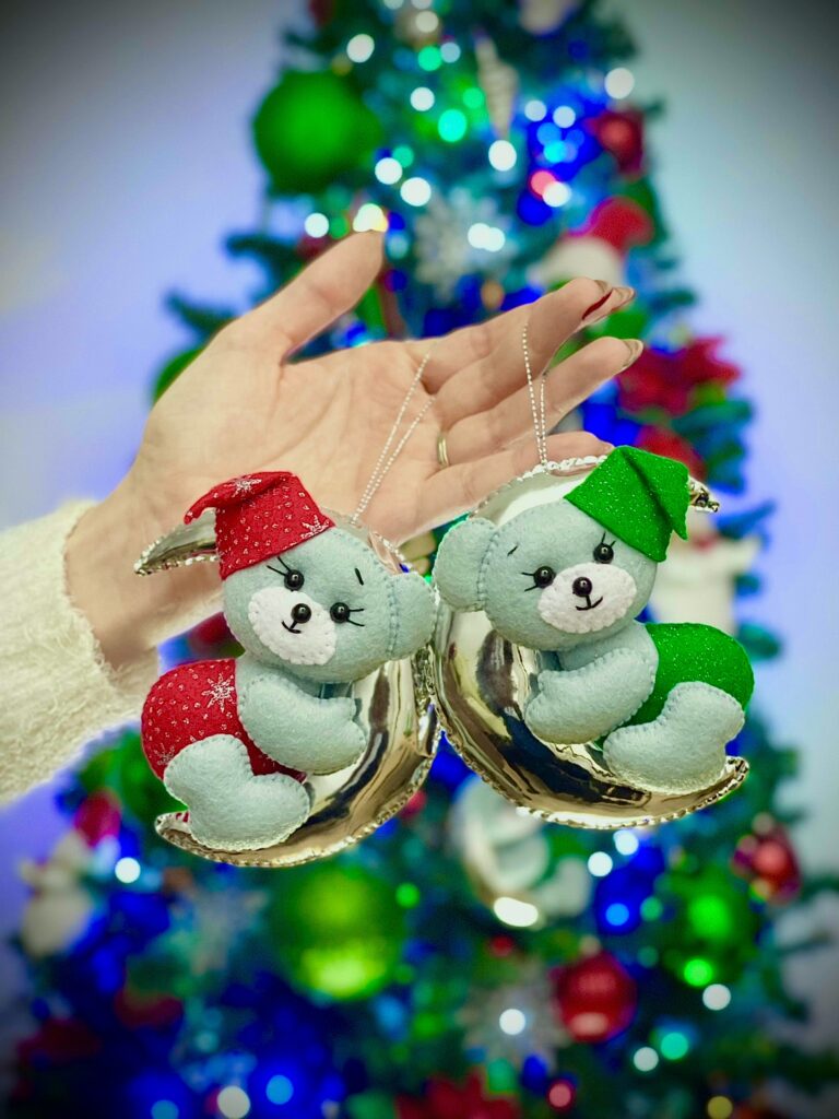 Felt Christmas ornaments hanging on silver twine, showing decorative twine used for handmade felt tree decorations