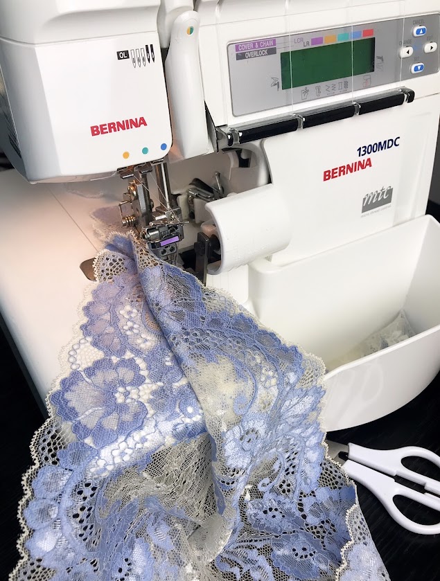 Blue lace fabric on Bernina sewing machine, showing DIY lingerie sewing process and colourful lingerie project inspiration.