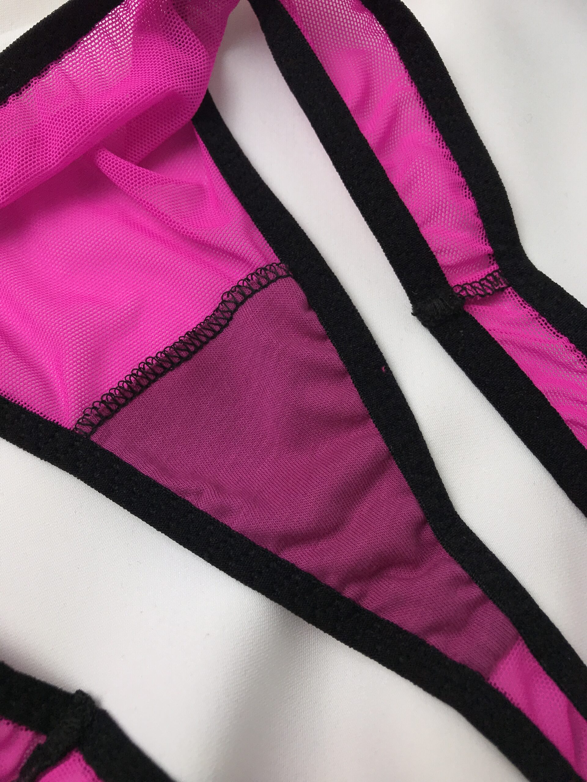 Close-up of bright pink panties with dark gusset lining, showing how fabric colour choices affect comfort in lingerie sewing.