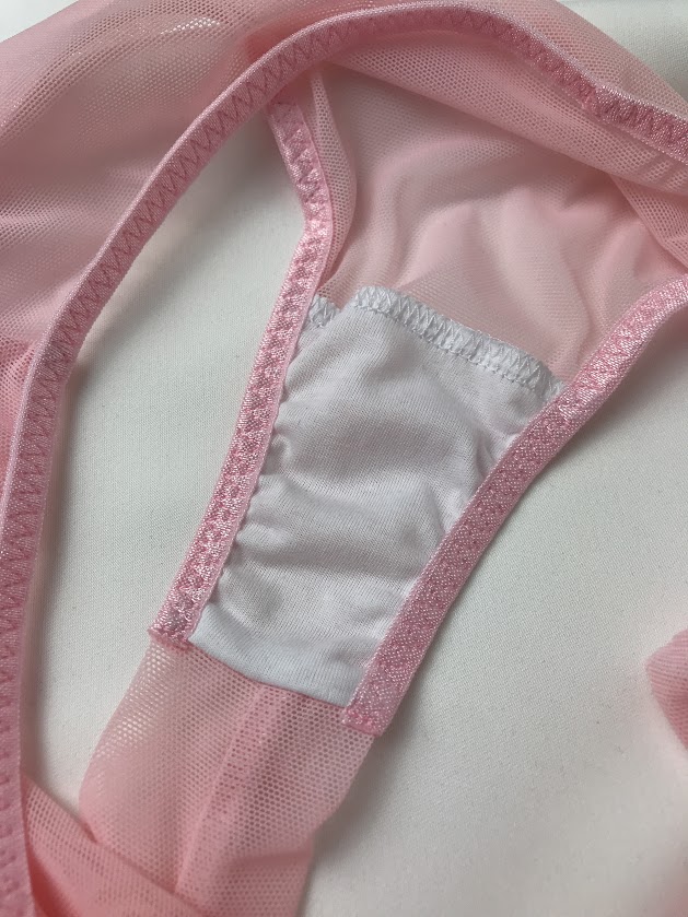 Close-up of pink panties with white cotton gusset lining, showing comfort and hygiene benefits in lingerie sewing and design.