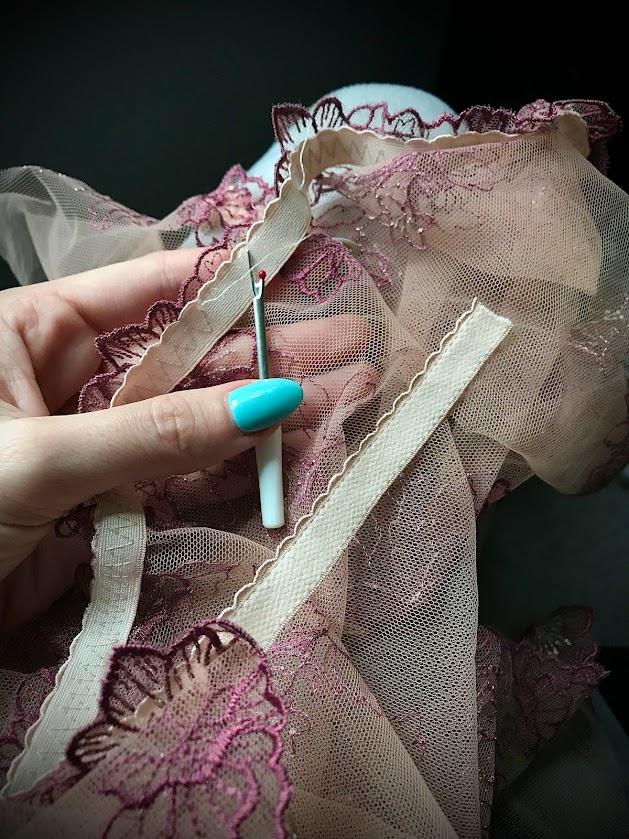 Seam ripper unpicking lace lingerie stitches, essential sewing tool for fixing mistakes cleanly without damaging delicate fabric