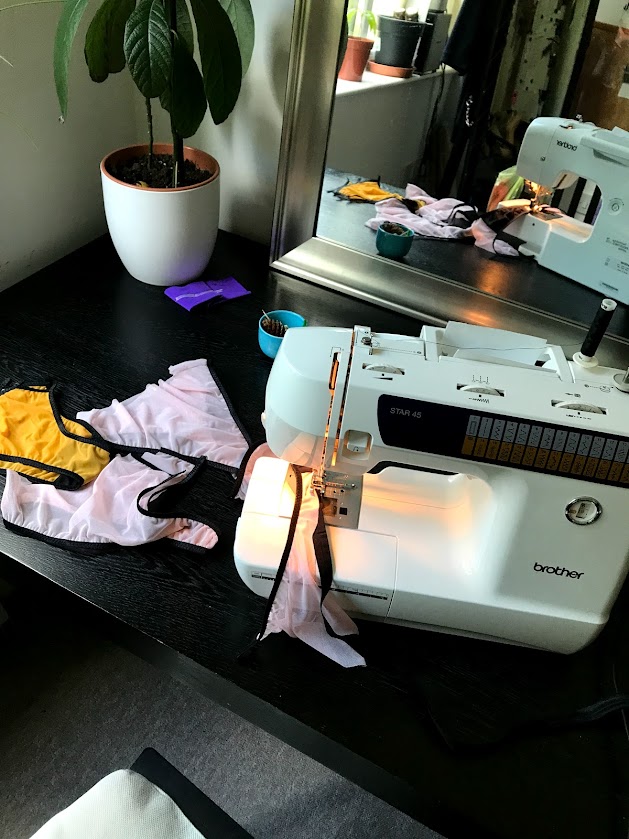 Brother sewing machine on a home table with stretch fabric, showing essential tools for making handmade lingerie