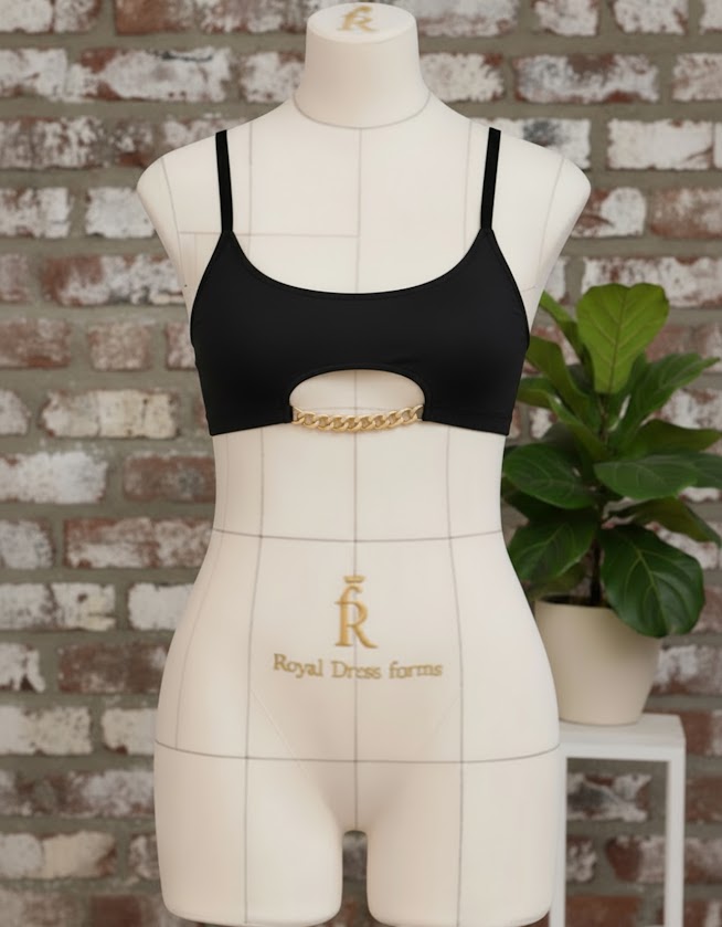 Black handmade Top-Bra “Mia” with gold chain detail displayed on a dress form during fitting and strap adjustment process.