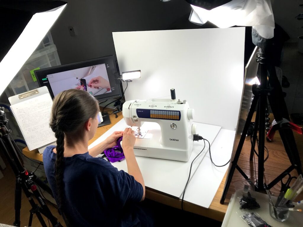 Lingerie sewing instructor filming a tutorial at a sewing machine, demonstrating elastic techniques for underwear making