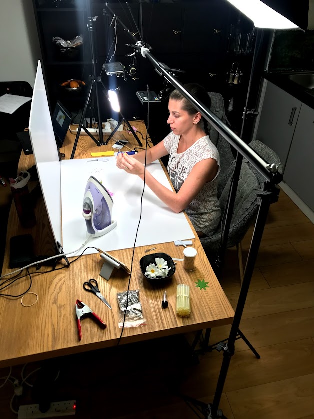 Extrovert creator filming a live sewing tutorial at home studio, keeping online connection with her DIY audience.