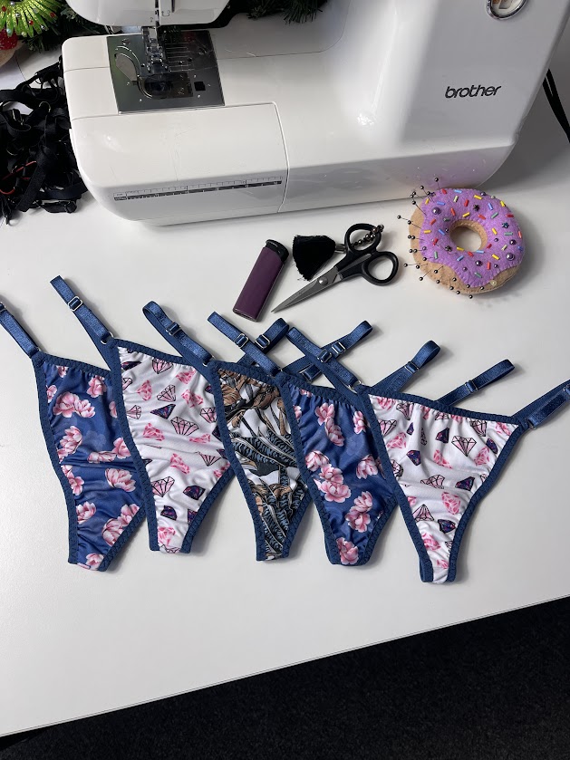 Sewing machine with five handmade thong panties using fold-over elastic, shown for underwear bulk sewing tutorial.