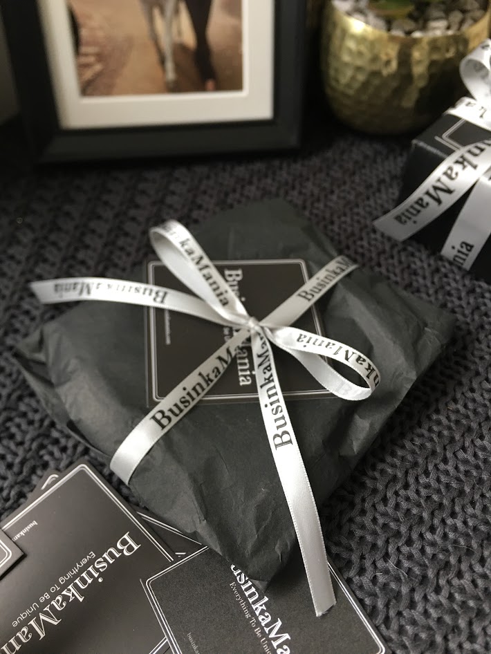 Wrapped BusinkaMania package with ribbon on fabric, showing handmade craft order and thank you gift for sewing pattern customers