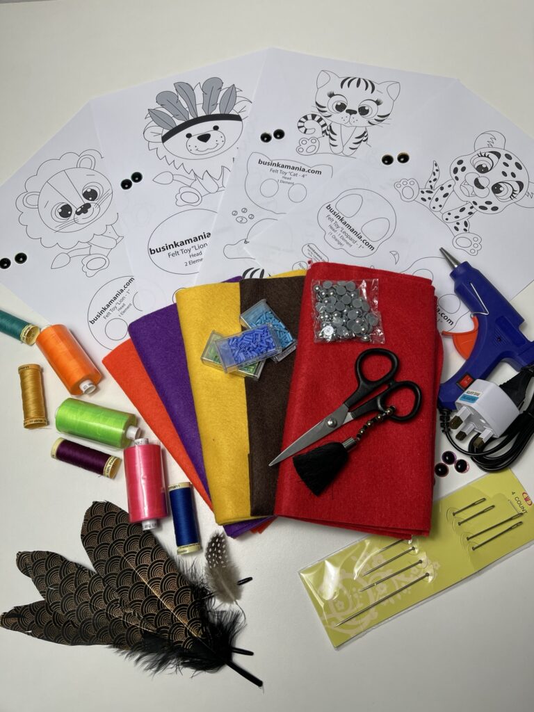 Felt plush sewing supplies with printed patterns, soft felt sheets, threads, needles and glue gun for handmade toys