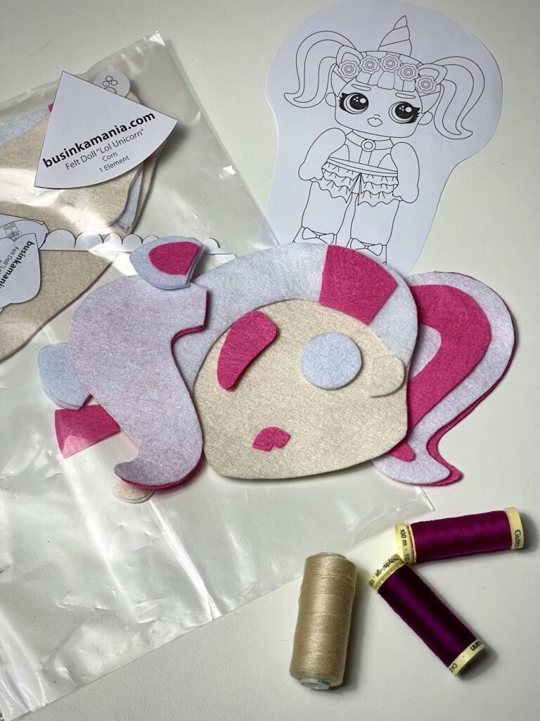 Felt doll sewing pattern with pre cut pieces in clear pocket folder for organised craft pattern storage
